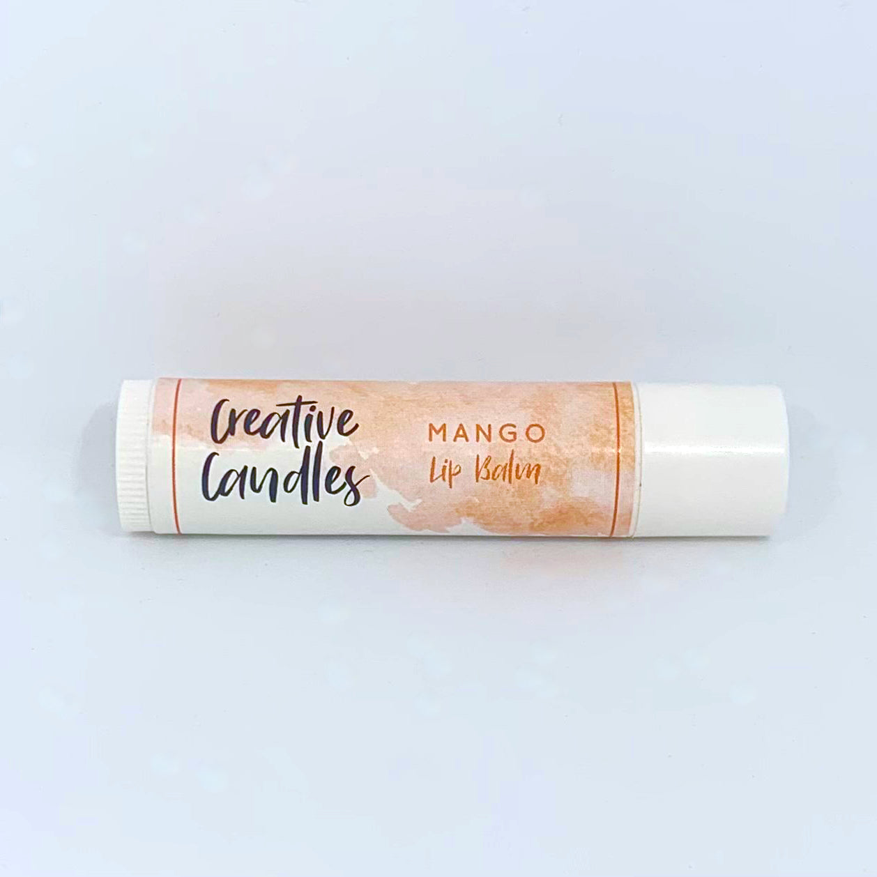 Mango Lip Balm against a white background.