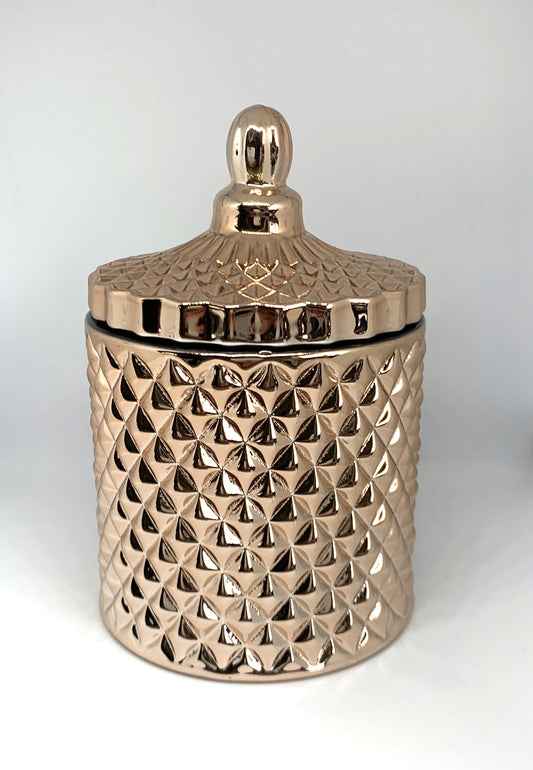 Rosegold geometric candle jar with lid on.