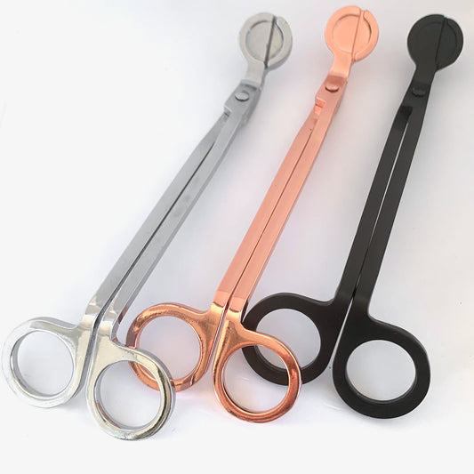 Set of three candle wick trimmers against white backdrop, in Silver, Rose Gold and Black.